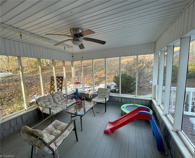 unfurnished sunroom featuring ceiling fan