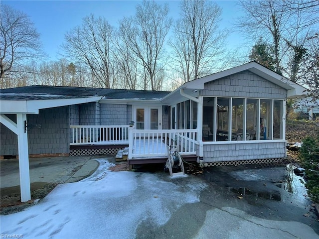 view of front of home featuring a sunroom and a deck