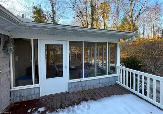 wooden deck with a sunroom