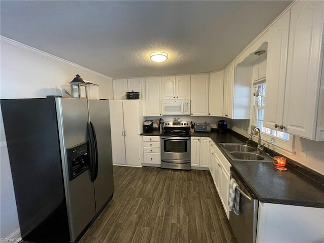 kitchen featuring white cabinets, sink, stainless steel appliances, and a textured ceiling