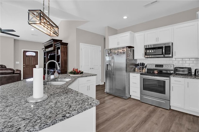 kitchen featuring sink, white cabinetry, and stainless steel appliances