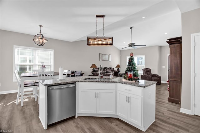 kitchen with stainless steel dishwasher, white cabinetry, sink, and a wealth of natural light