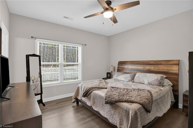 bedroom with ceiling fan and dark hardwood / wood-style flooring