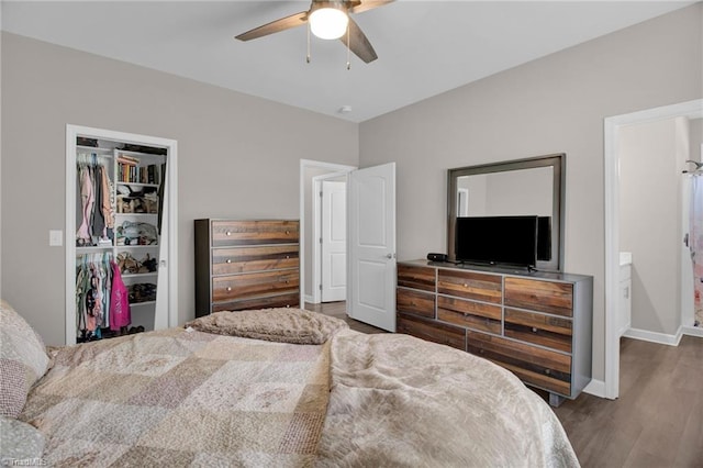 bedroom with ceiling fan, a closet, and dark wood-type flooring