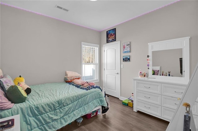 bedroom with dark hardwood / wood-style floors