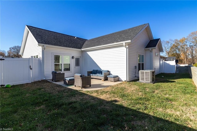 back of property with outdoor lounge area, central AC unit, a patio area, and a lawn