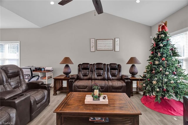 living room featuring lofted ceiling with beams, light hardwood / wood-style flooring, and ceiling fan