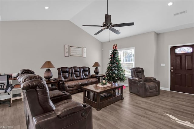 living room with ceiling fan, hardwood / wood-style floors, and high vaulted ceiling