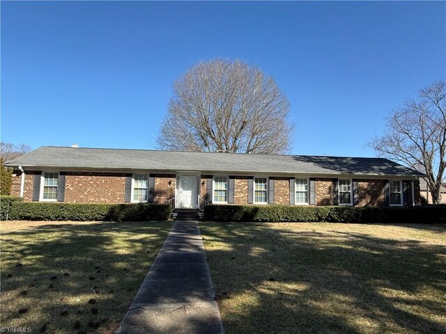 ranch-style home with brick siding and a front yard