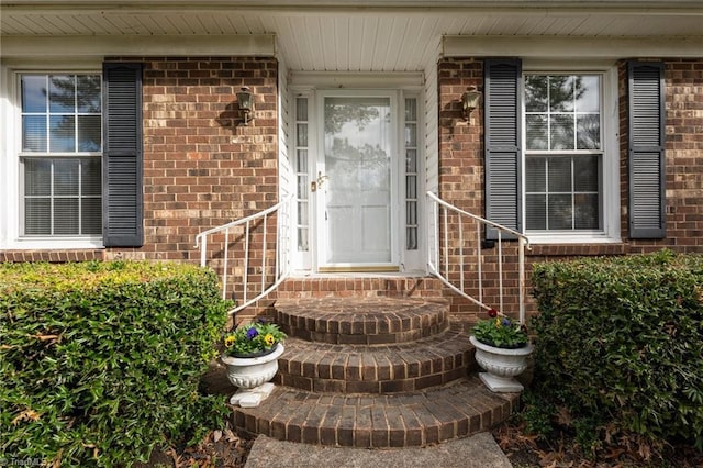 doorway to property with brick siding