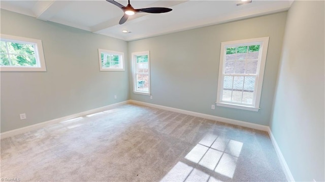 empty room featuring a ceiling fan, beam ceiling, light carpet, and baseboards