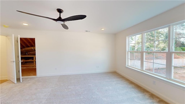 unfurnished room with recessed lighting, light colored carpet, and baseboards