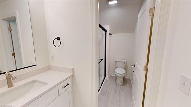 bathroom with vanity, toilet, and wood finished floors