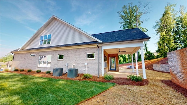 back of house featuring brick siding, a yard, a patio area, ceiling fan, and central AC