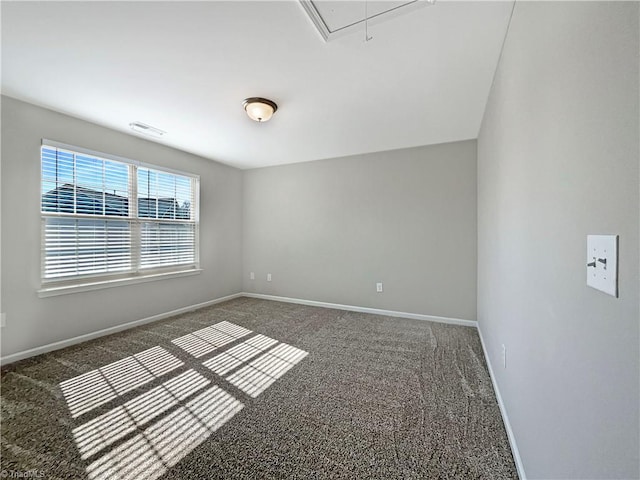 spare room featuring attic access, carpet flooring, visible vents, and baseboards