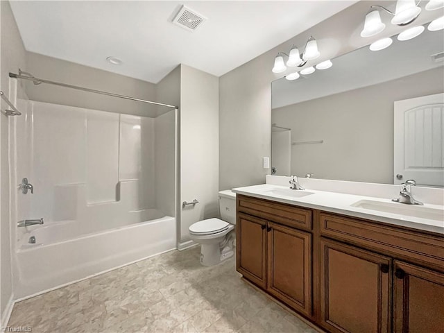 bathroom featuring toilet, double vanity, visible vents, and a sink