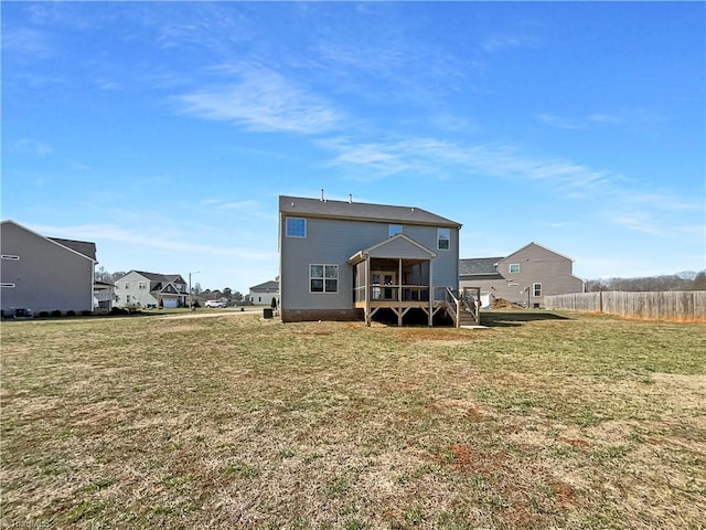 back of house featuring a sunroom, a yard, and fence