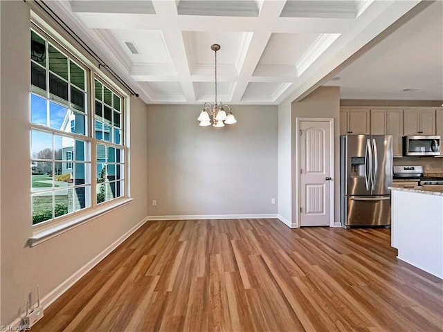 interior space with wood finished floors, visible vents, baseboards, beam ceiling, and an inviting chandelier