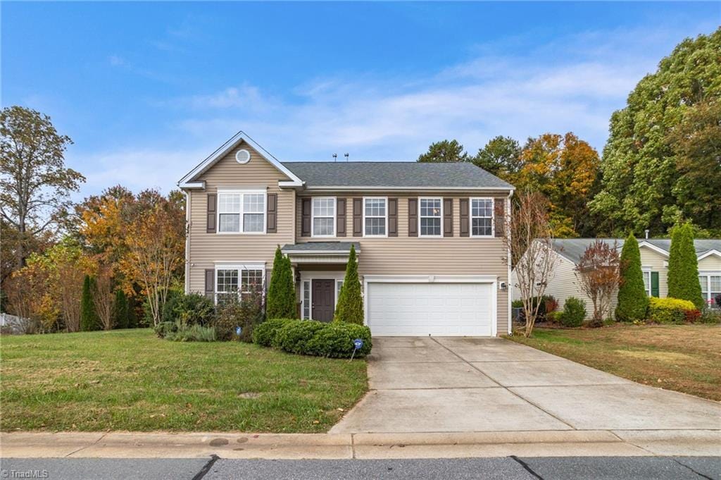 view of front of home with a garage and a front yard