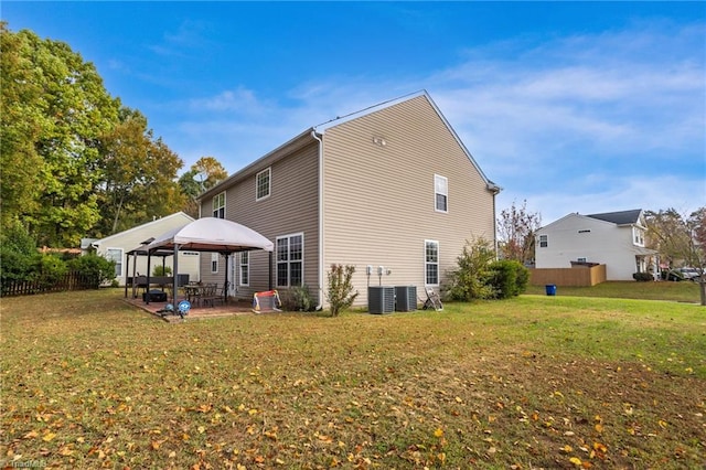 back of property with central AC unit, a patio, a lawn, and a gazebo