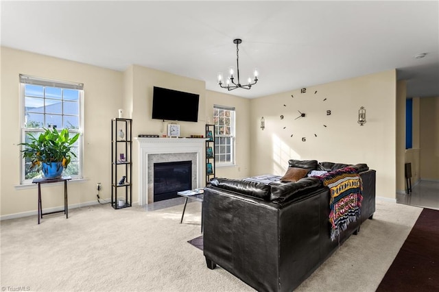 living room featuring light colored carpet, a chandelier, and a high end fireplace