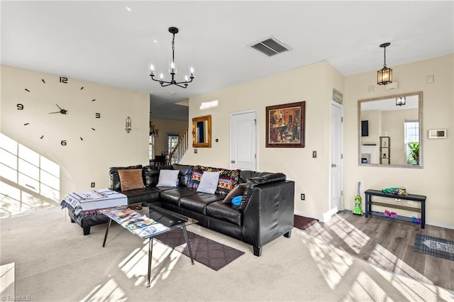 living room with wood-type flooring and a chandelier