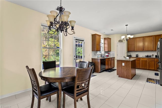 dining area featuring sink, a notable chandelier, and light tile patterned floors