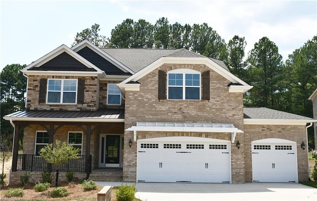 craftsman inspired home with a garage and covered porch