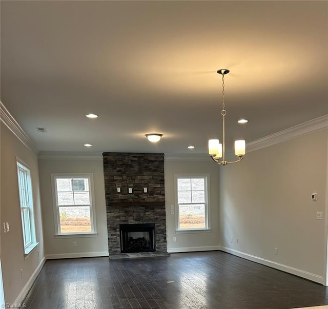 unfurnished living room with a fireplace, an inviting chandelier, crown molding, and dark wood-type flooring