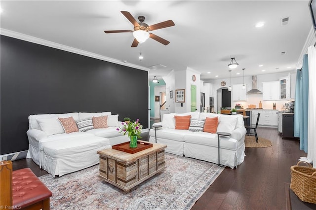 living room featuring a ceiling fan, visible vents, recessed lighting, dark wood-type flooring, and crown molding