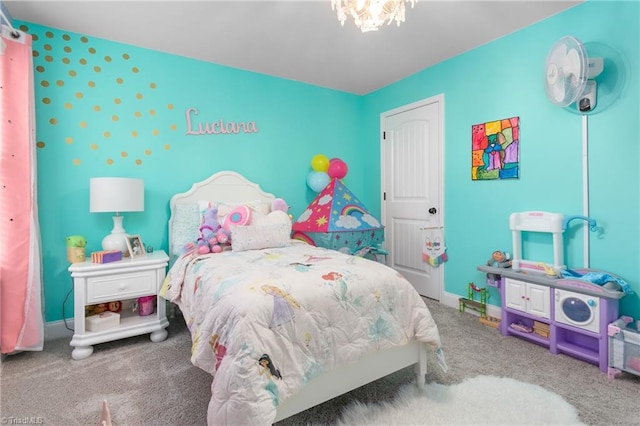 carpeted bedroom with baseboards and a notable chandelier