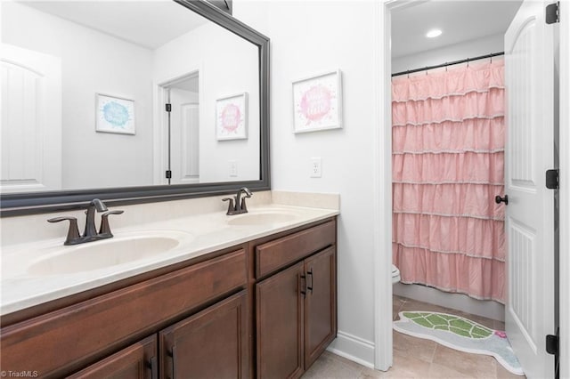 full bath with a sink, toilet, a shower with shower curtain, and double vanity