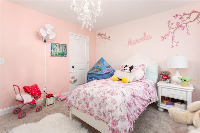 carpeted bedroom with baseboards and a chandelier