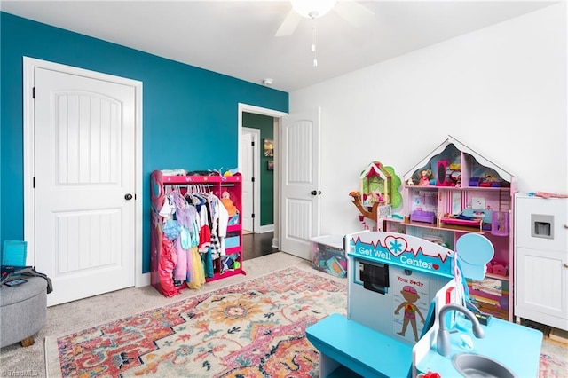 playroom with a ceiling fan and carpet floors