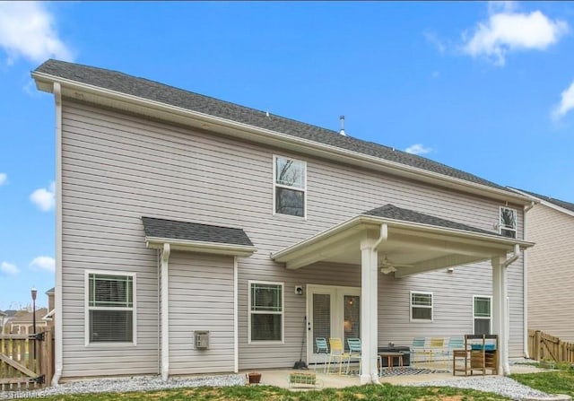 back of property featuring a patio, fence, and a shingled roof