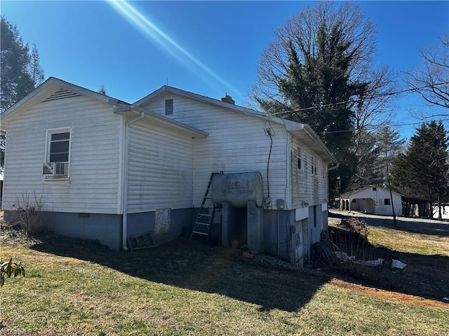 view of side of property featuring crawl space, cooling unit, and a yard