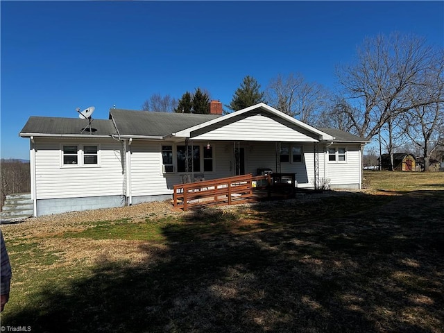 view of front facade with covered porch and a chimney