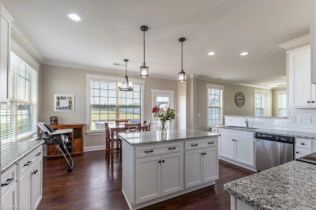 kitchen with dark wood-style floors, backsplash, stainless steel dishwasher, ornamental molding, and a sink