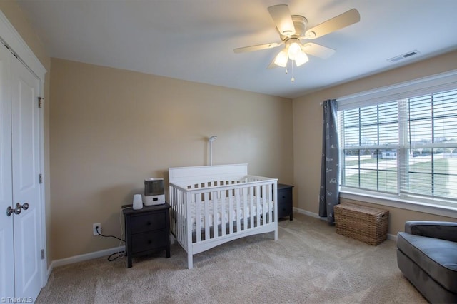 bedroom with carpet floors, baseboards, visible vents, and a closet