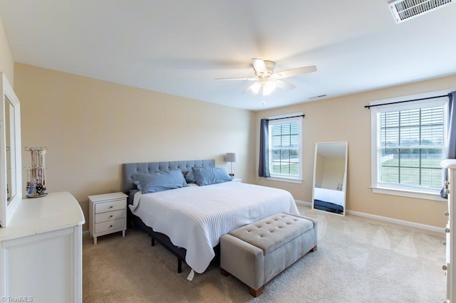 bedroom featuring visible vents, ceiling fan, light carpet, and baseboards