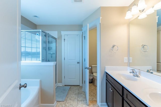 bathroom featuring toilet, a sink, a shower stall, a bath, and double vanity