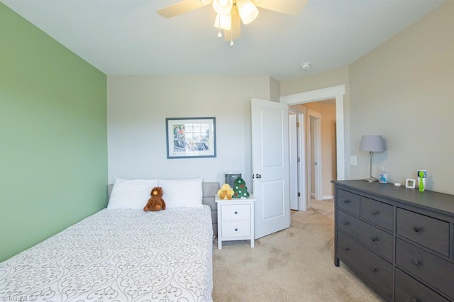 bedroom with a ceiling fan and light colored carpet