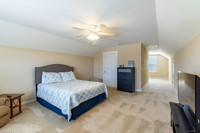 bedroom with visible vents, vaulted ceiling, and light carpet