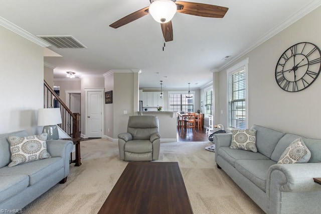 living room with visible vents, crown molding, and light carpet