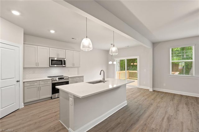 5421 High Valley Ln, Winston-Salem, NC 27104 - kitchen featuring stainless steel appliances, healthy amount of natural light, light wood finished floors, decorative backsplash, and recessed lighting