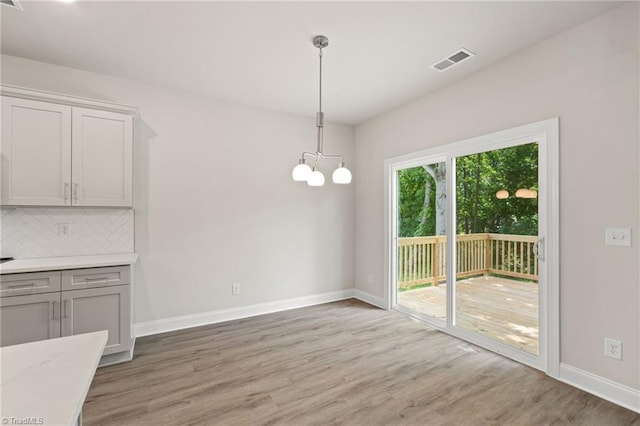 5421 High Valley Ln, Winston-Salem, NC 27104 - unfurnished dining area with light wood-style floors and a chandelier