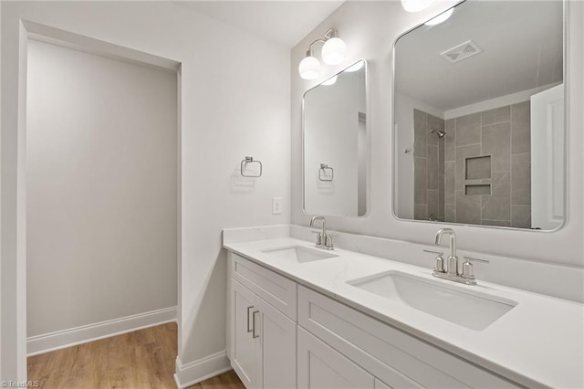 5421 High Valley Ln, Winston-Salem, NC 27104 - full bathroom with wood finished floors, double vanity, and a tile shower