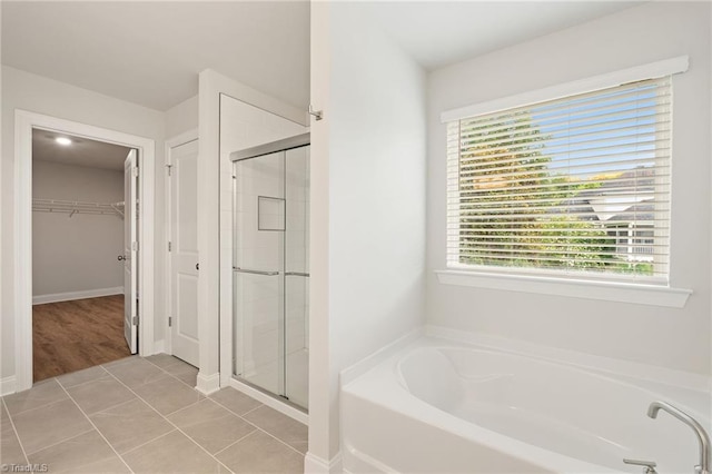 5421 High Valley Ln, Winston-Salem, NC 27104 - full bathroom featuring a garden tub, a walk in closet, a shower stall, and healthy amount of natural light