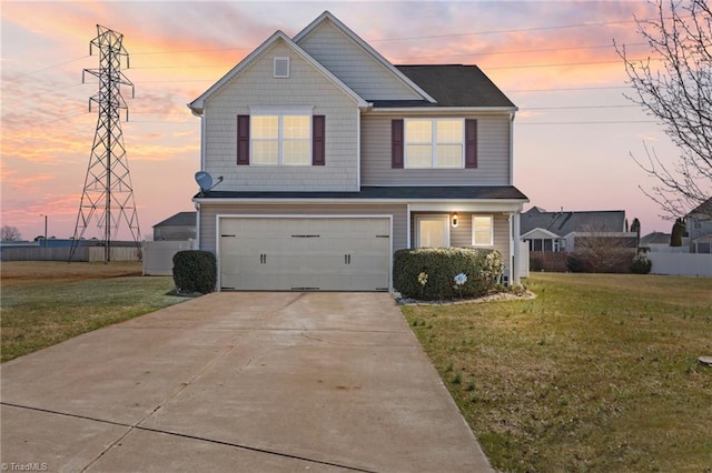 view of front of house featuring an attached garage, driveway, and a front yard