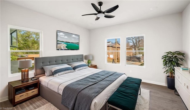 bedroom featuring ceiling fan and dark wood-type flooring